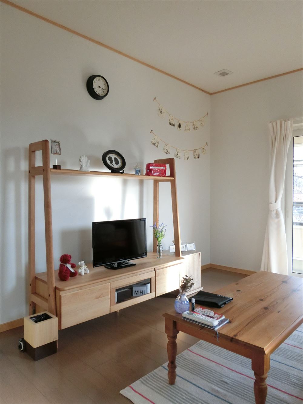 木製のテレビ台とローテーブルが設置されたシンプルでナチュラルな雰囲気